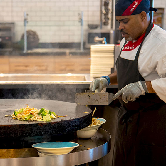 A Sodexo employee working the stir fry station in Brooks Dining Hall on our Gorham campus.