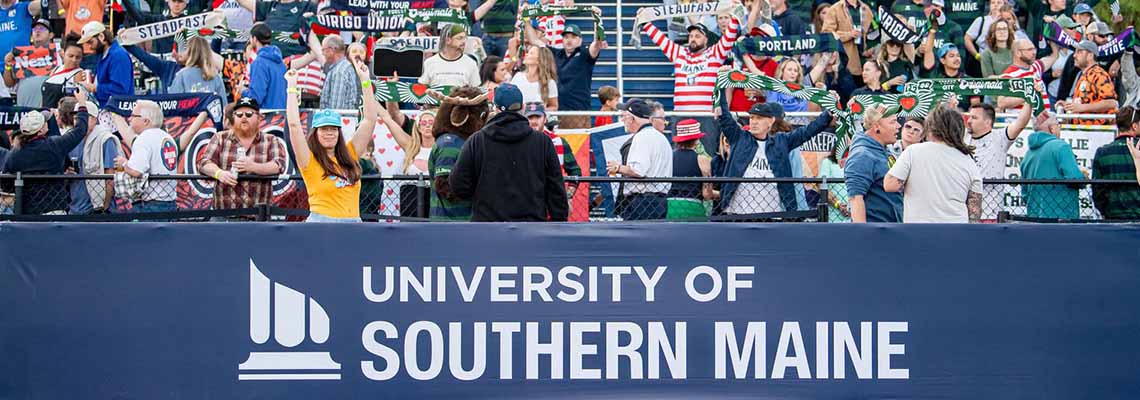 A banner with the USM logo is mounted at the base of the seating area at Fitzy Stadium.