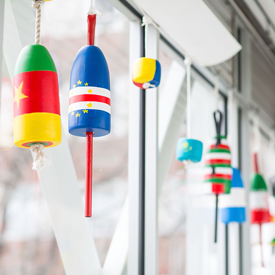 Buoys painted with the flag designs of different countries.