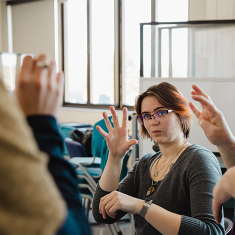 A group of students practice American Sign Language together.