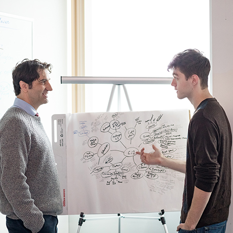 a faculty member and a student brainstorm an idea.
