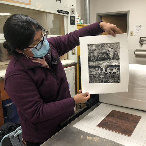 Student Sisa Lema works on a print in the studio.