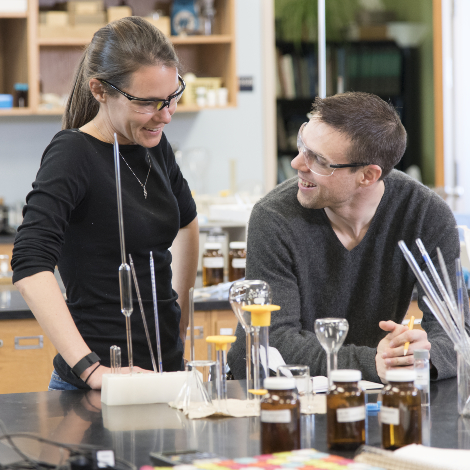 Two students chat during an experiment in the lab.