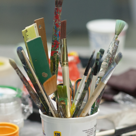 A close-up of paintbrushes in a cup.