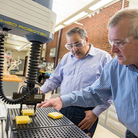 Two University of Southern Maine engineering faculty members work in a lab.