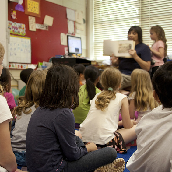 A teacher reads to a classroom of children.