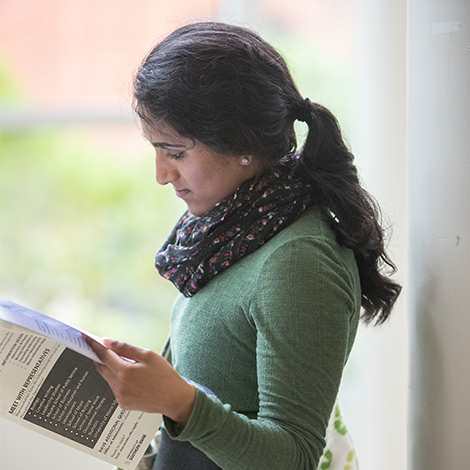 A student reads in the hallway.