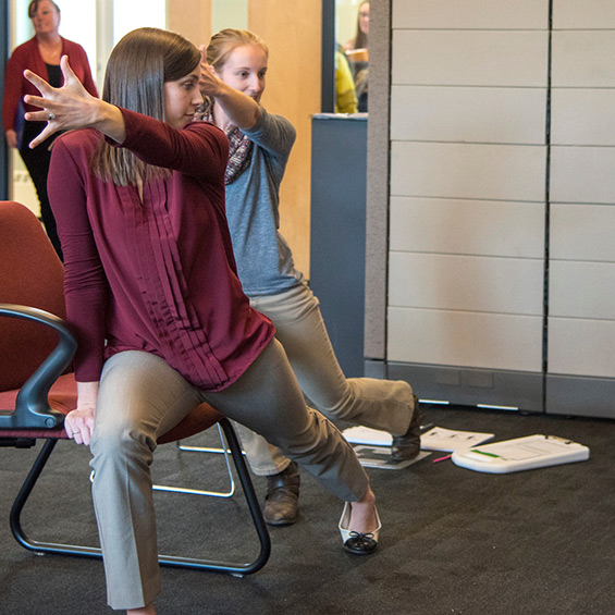 Two student interns demonstrate streching.