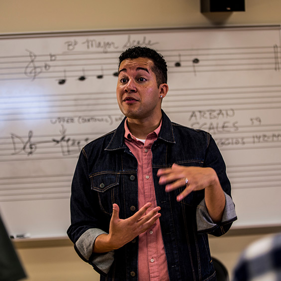 A graduate student instructs a music course.