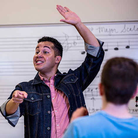 A graduate student instructs a music course.