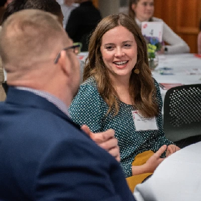 Two people engaged in conversation at a table.
