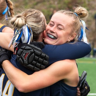 Upon winning the 2023 LEC championship game, field hockey players grabbed the nearest teammate for a celebratory hug.