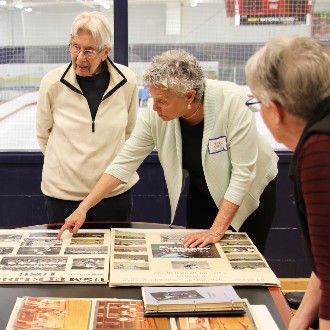 Archival photos helped jog the memories of former players who attended a reception to celebration Paula Hodgdon's induction into the Maine Field Hockey Association Hall of Fame.