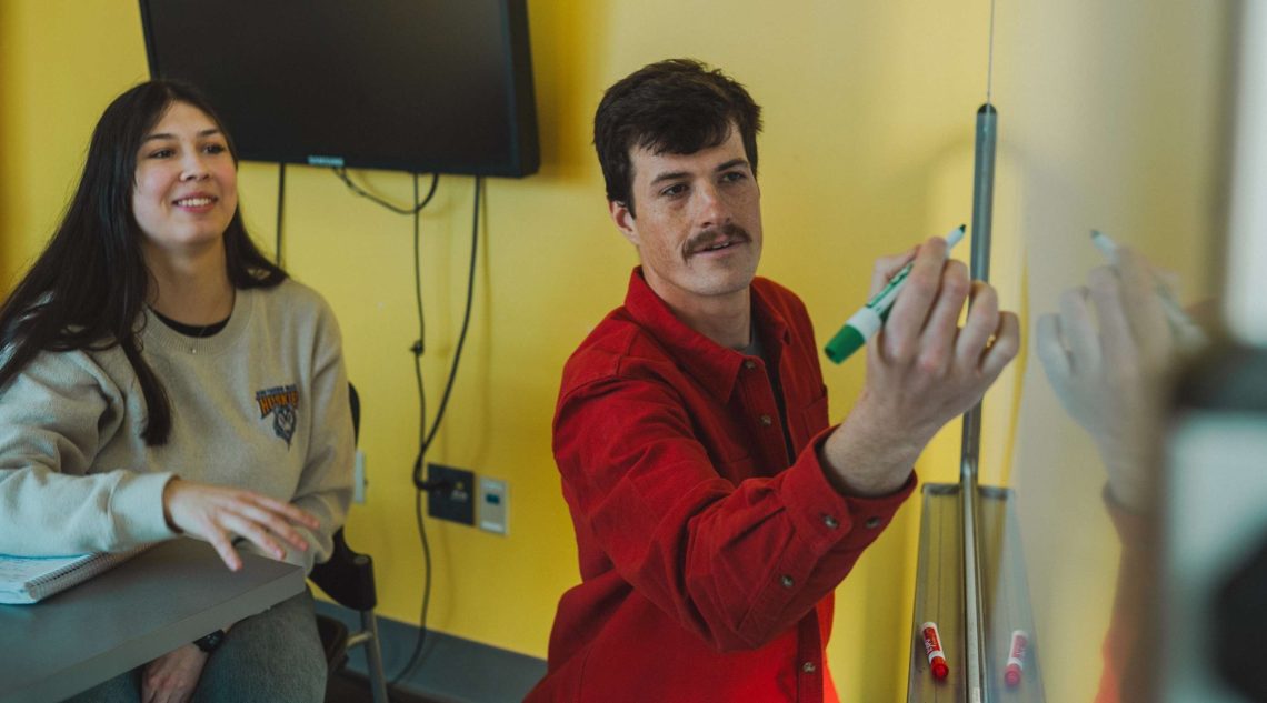 Adult learner coach helping a student through their studies.