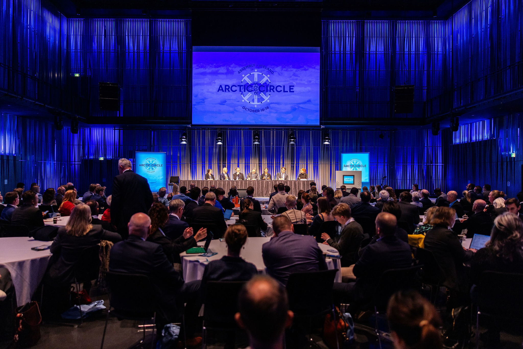 Crowded audience seated at Arctic Circle Assembly presentations, with rows of attendees filling the venue.