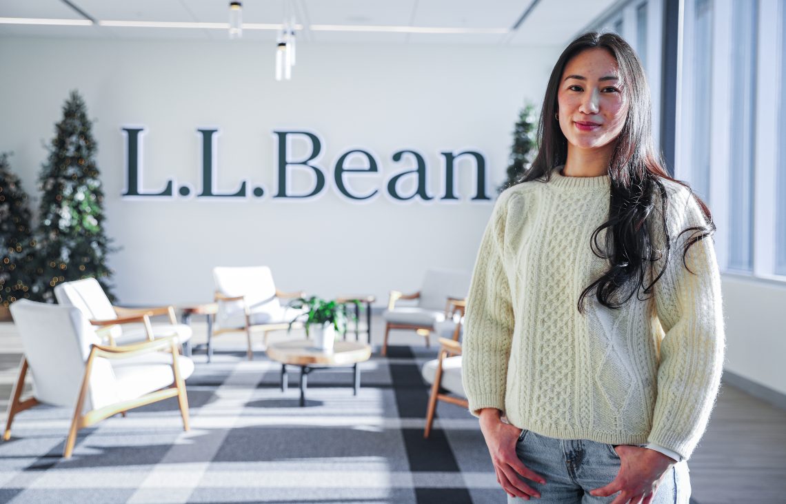 Mandy Ho poses in front of the L.L.Bean sign at their head quarters.