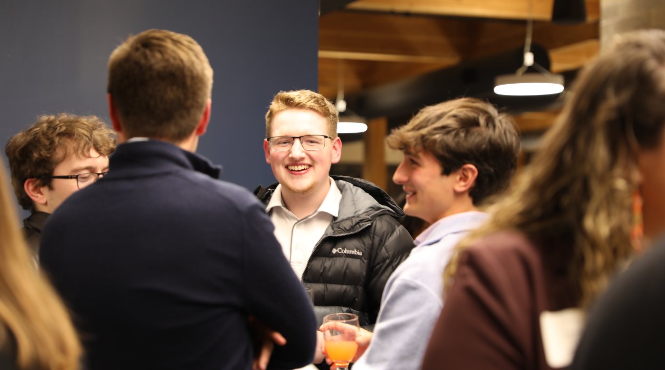 Collin Page and peers laugh, while enjoying mocktails at the Career Hub Networking Dinner this November
