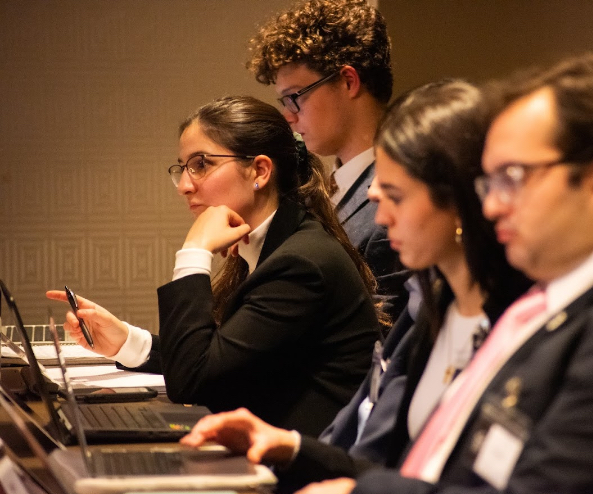 Emma (left) at a Model UN conference in Montreal during her time as a USM student