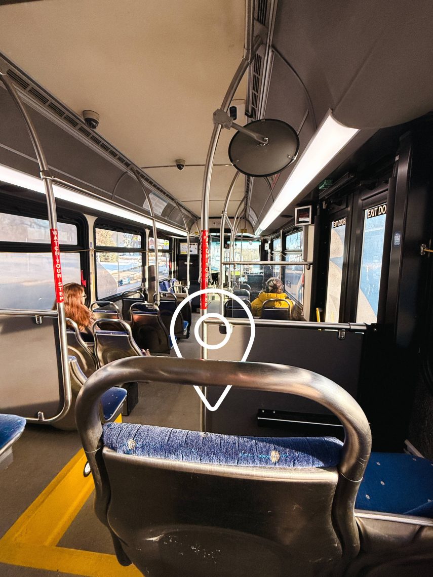 Interior of USM's Husky Line bus, which shows an animated location pin point above a seat in the bus.