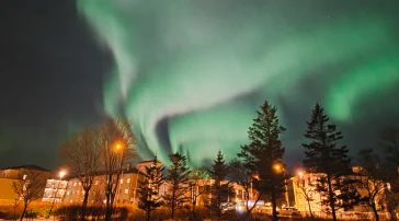 Northern lights (aurora borealis) glowing above Reykjavik, Iceland, photographed by USM Fulbright scholar Emma