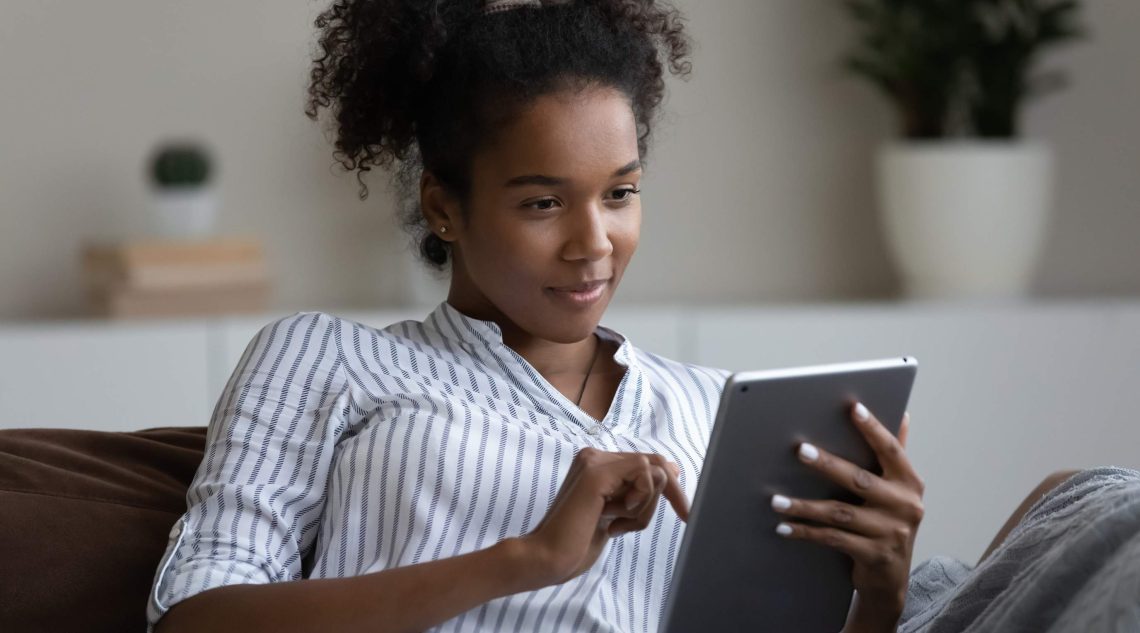 Woman editing content on a tablet.