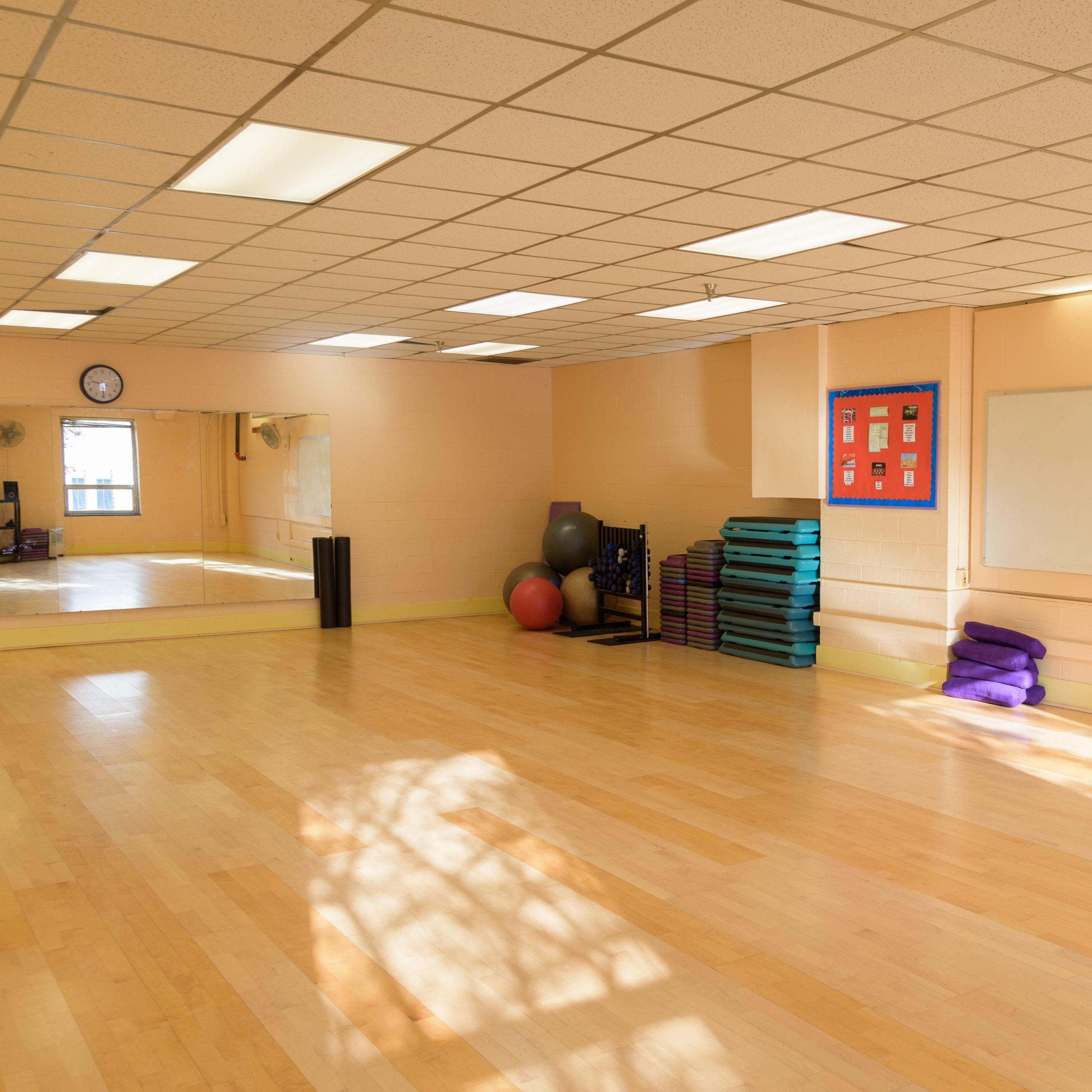 Yoga and dance studio inside Sullivan Gym on the University of Southern Maine’s Portland campus, featuring an open floor space with mirrors and natural light.