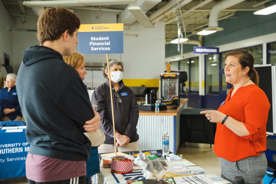 Students speak with a staff member at the Student Financial Services table during USM's Admitted Students Day resource fair