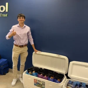 Nicholas Maruo giving thumbs up in front of Bristol Seafood signage.