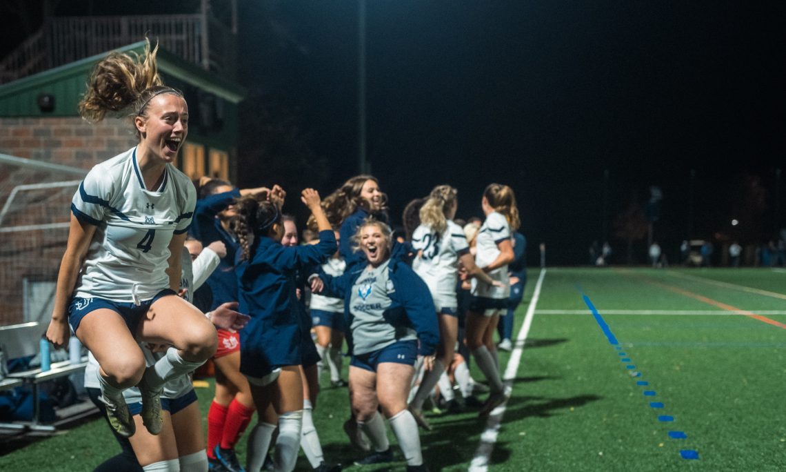Bridgette Toland jumping in the air in celebration after a soccer win.