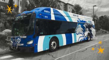The University of Southern Maine's Husky Line bus stops on the street to pick up students. The background around the bus is black and white, and there are hand drawn yellow stars on either side of the bus.