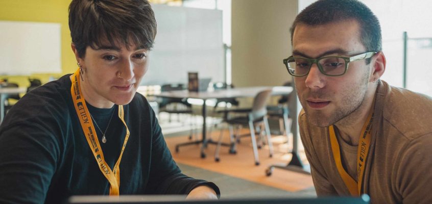 Technology coach helping a student with computer guidance.