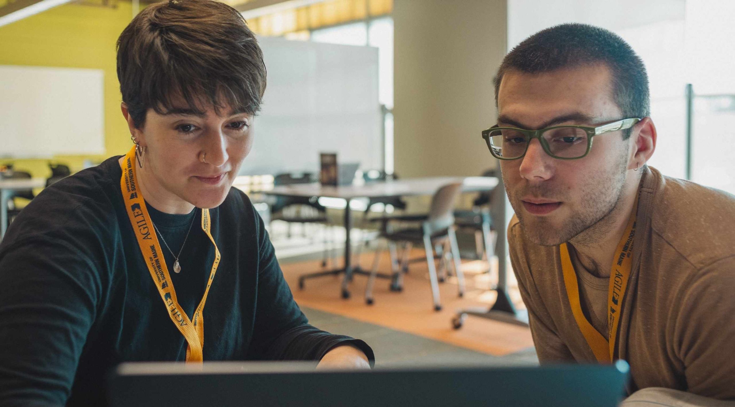 Technology coach helping a student with computer guidance.