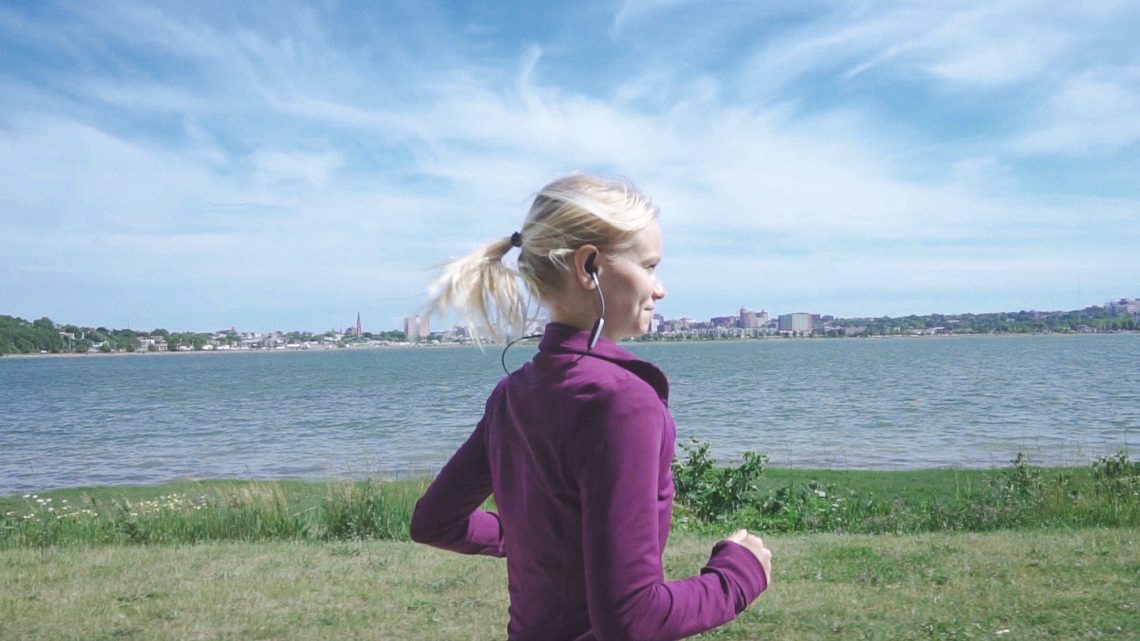 A student runs along the path at Back Cove in Portland.