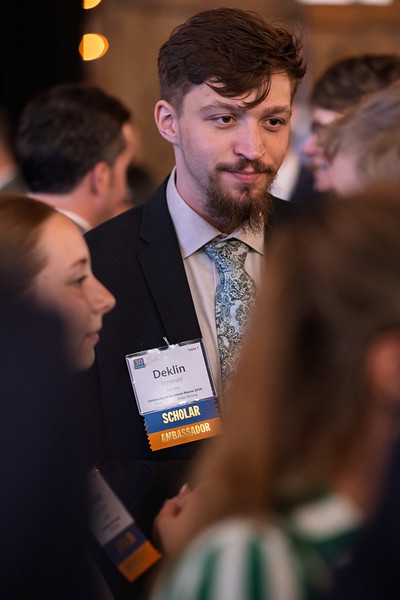 Deklin Fitzgerald, USM's Mitchell Scholar Ambassador, chats with other scholars at an event.