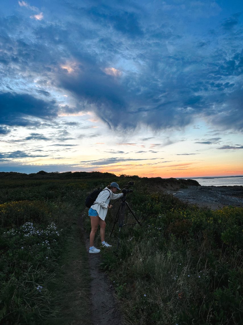 The post's author photographs the ocean from a beach at sunset, camera mounted on a tripod.