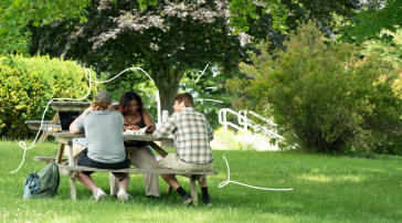 Students study together at a picnic table, surrounded by illustrated doodles.