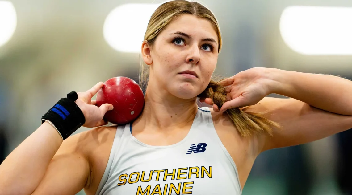 Zoe Barnes mentally preparing with shot put loaded on shoulder ahead of her heat.
