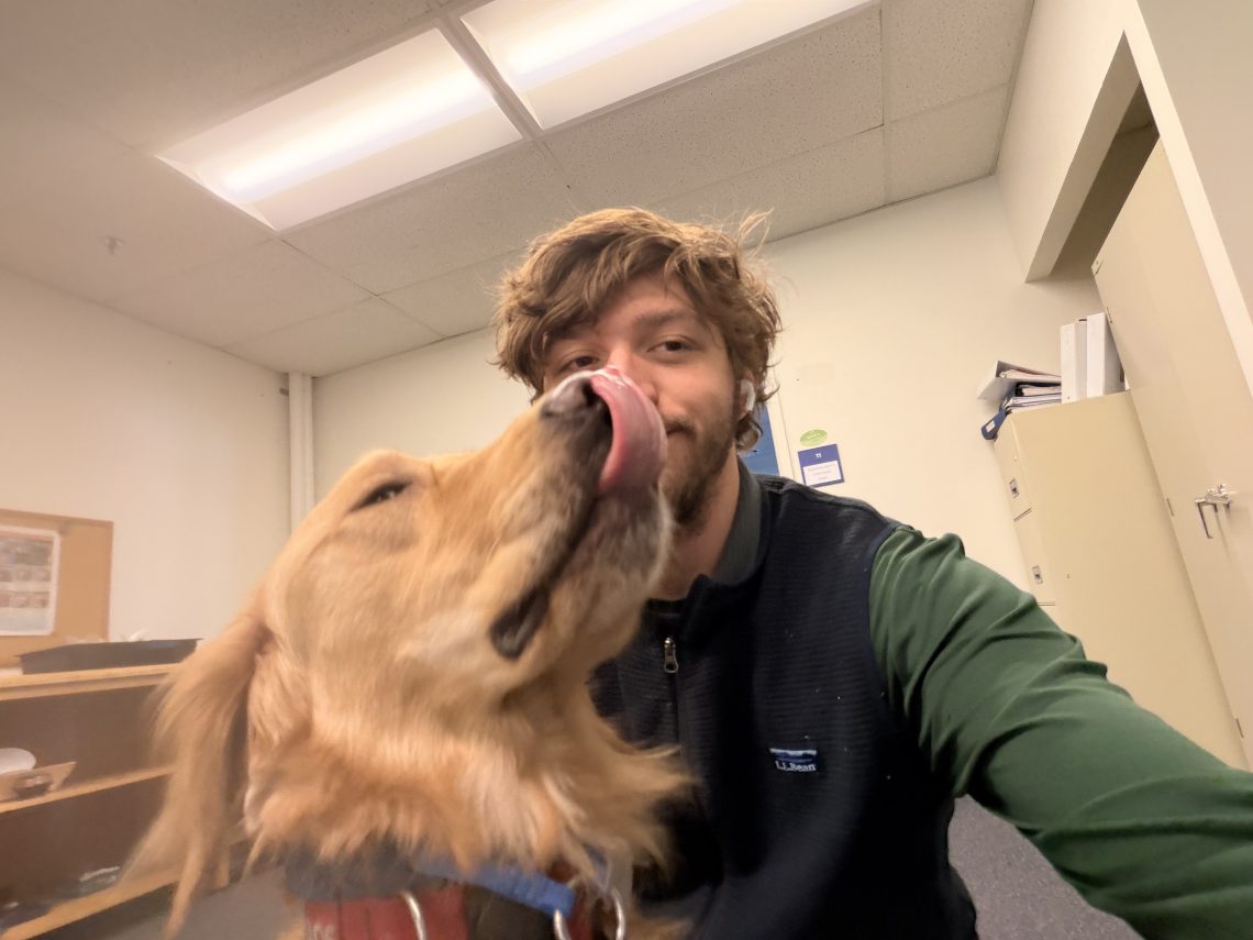 Deklin Fitzgerald poses for a selfie with Chaos, a golden retriever and Maine's only crisis response canine.