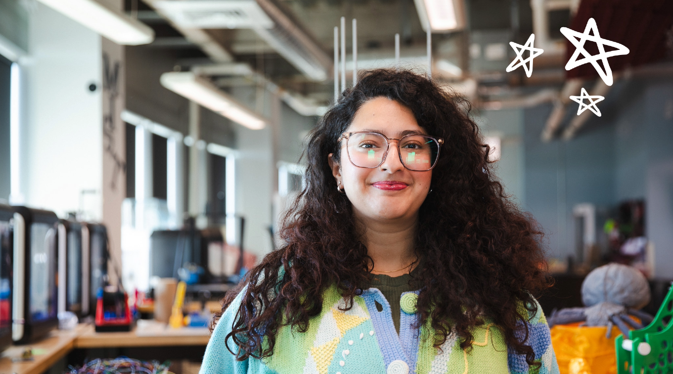 Prashiddhi Pokhrel, a graduate student and MIST Lab student employee, in the Maker Innovation Studio at USM. White star doodles overlay the image in the upper right hand corner.