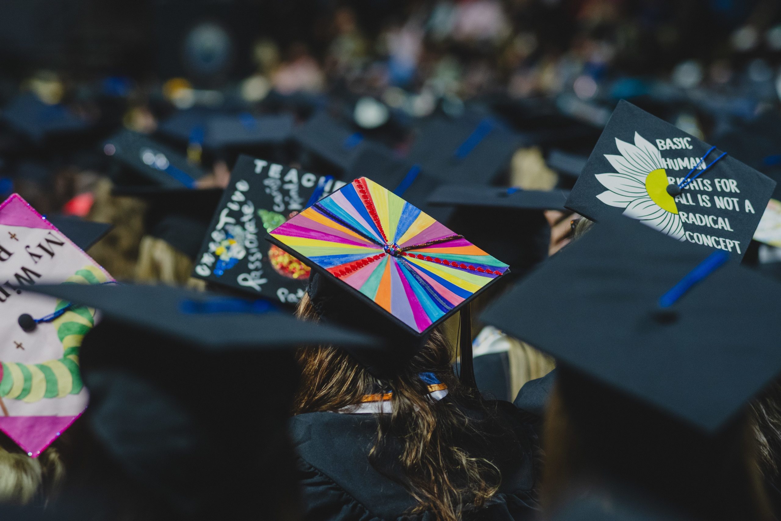 Decorated graduation caps with colorful designs at USM commencement ceremony