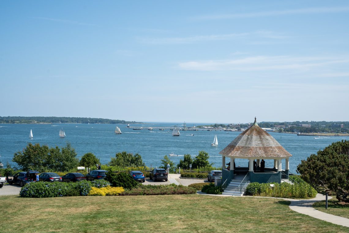 Eastern Promenade gazebo overlooking Casco Bay with sailboats on the water and Portland waterfront in the distance