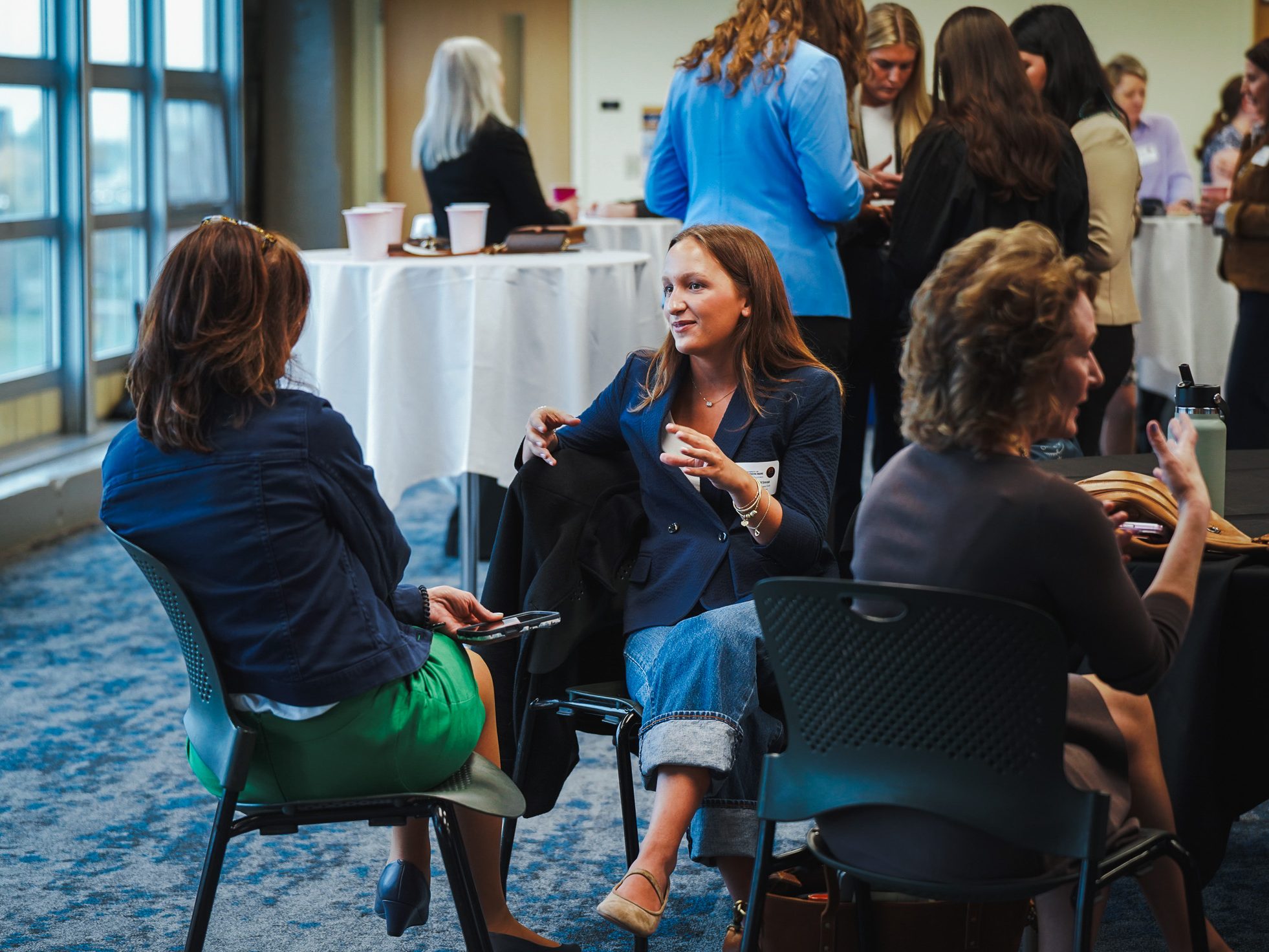 Attendees connect in small groups during a University of Southern Maine Women in Business Club networking event.