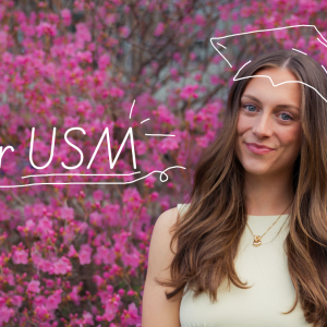 Bridgette Toland smiles in front of a flowering pink tree. Text reads "Dear USM," with an illustrated graduation cap drawn above her head.