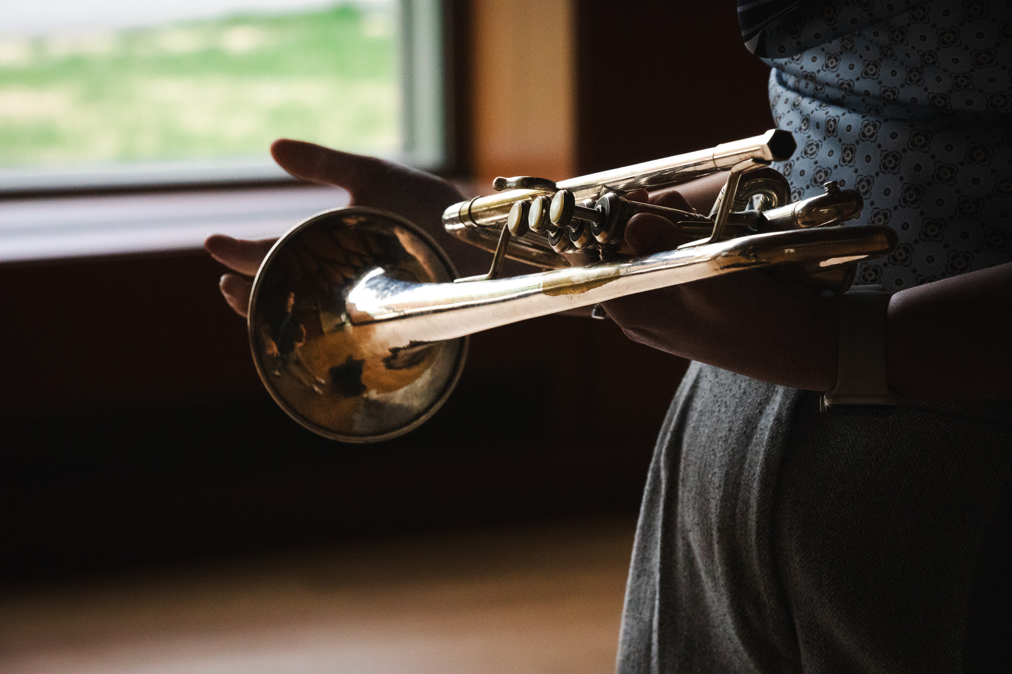 Hannah Paterson holds her trumpet by a window in the Crewe Center.