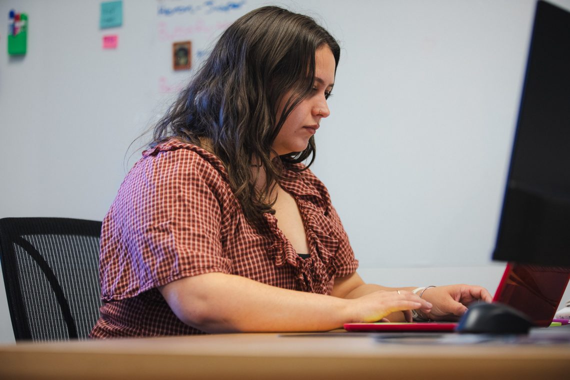 Olivia O'Donnell works at her desk at mainelove's Westbrook office.