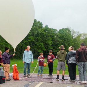 Students prepare to launch a research balloon to the edge of space.
