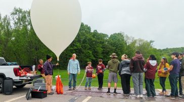 Students prepare to launch a research balloon to the edge of space.