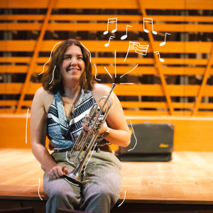 Hannah Paterson smiles while holding her trumpet on the Crewe Center's stage, with illustrated music notes and an American flag floating around her.