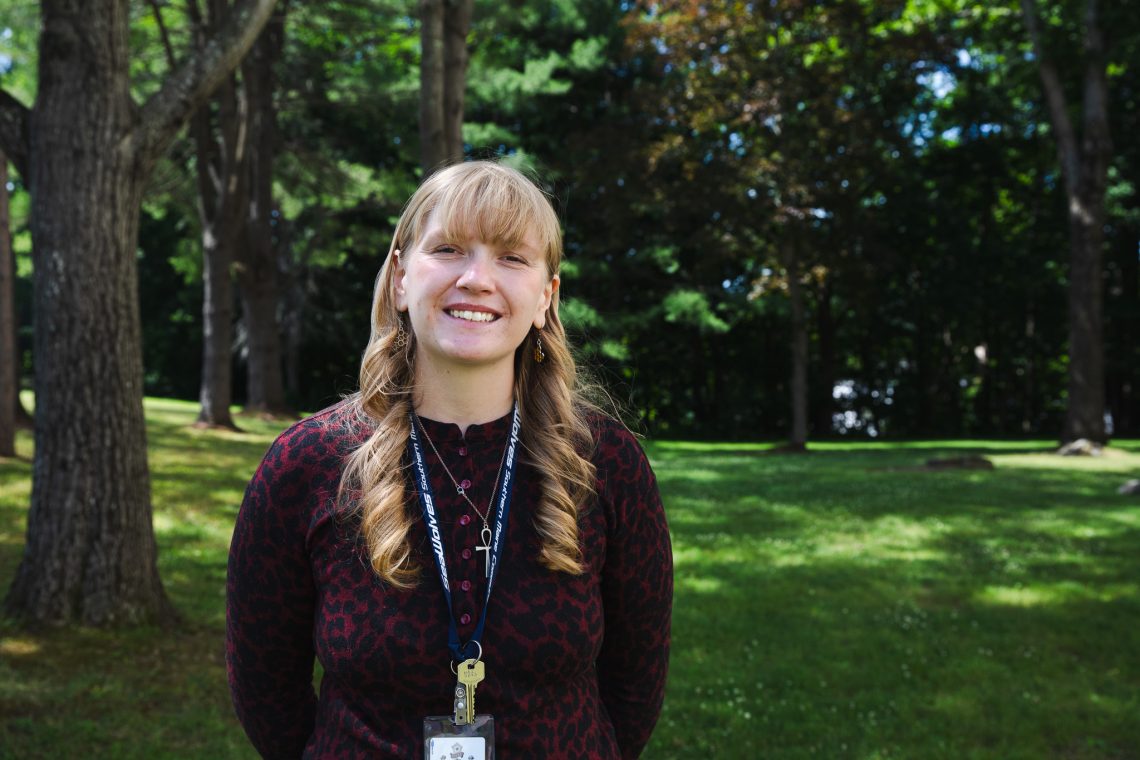 Camdyn Johnson smiles outdoors outside the Maine State Museum.