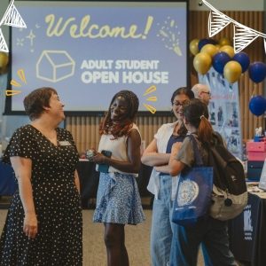 Gina Capra chatting with students at a previous Adult Students Open House at USM.